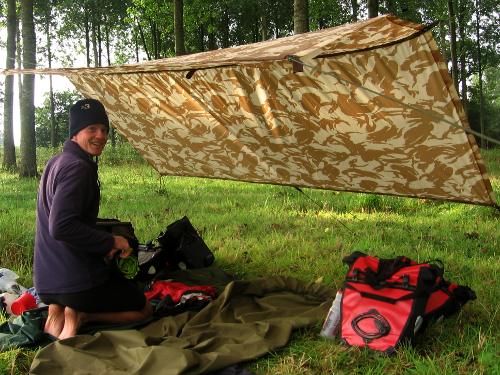Camped beneath a tarp in a forest