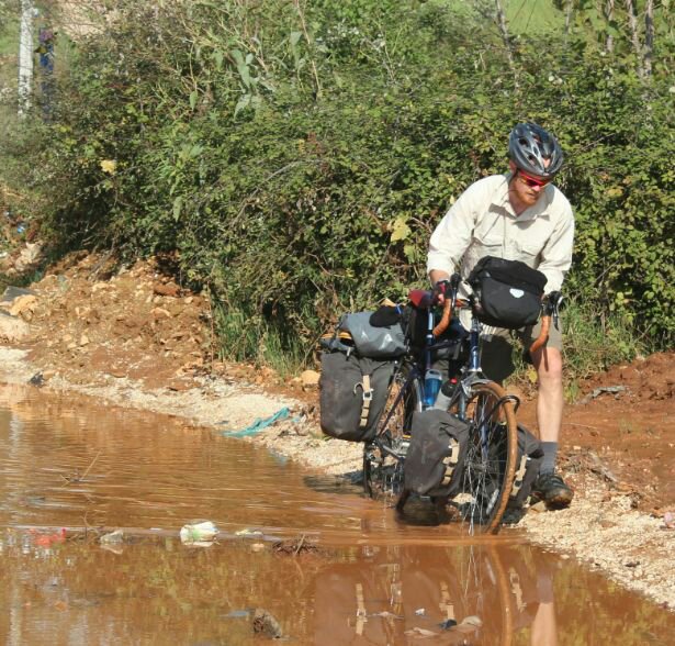 Wheeling through mud in Albania
