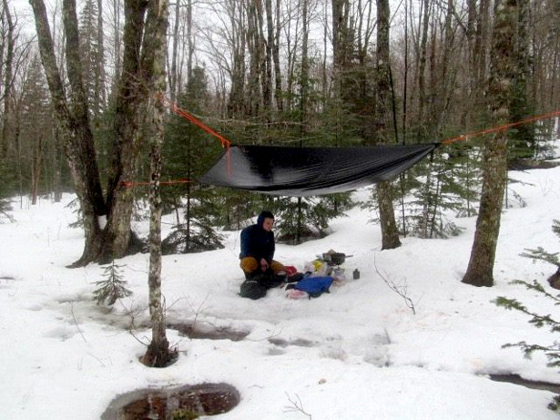 Cooking breakfast while avoiding puddles after the rain passed. The night before, there had been about a metre of snow.